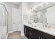 Sleek bathroom featuring a double vanity with dark cabinets, white counters, and modern fixtures at 1311 English Nw St, Atlanta, GA 30318