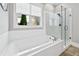 Luxurious soaking tub and glass-enclosed shower, complemented by white subway tile at 1311 English Nw St, Atlanta, GA 30318