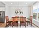 Bright dining area featuring a modern light fixture, stainless steel appliances, and hardwood floors at 1311 English Nw St, Atlanta, GA 30318