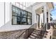 Elegant front entrance with brick stairs, black iron railings, and a modern white facade at 1311 English Nw St, Atlanta, GA 30318