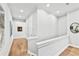 Well-lit hallway on the second floor with hardwood floors and neutral paint, creating a seamless flow at 1311 English Nw St, Atlanta, GA 30318