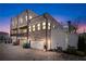 Rear exterior view showcasing brick facade, garages, and paved driveway during sunset at 1311 English Nw St, Atlanta, GA 30318