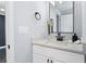 Bright bathroom featuring a white vanity with quartz countertop, modern black fixtures, and soft, neutral wall color at 1931 Selwyn Dr, Decatur, GA 30035