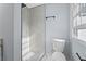 Contemporary bathroom with walk-in shower featuring marble-style tile and a modern toilet next to a window at 1931 Selwyn Dr, Decatur, GA 30035