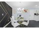 Stylish dining area featuring a modern chandelier, a glass-top table, and eye-catching wall decor at 1931 Selwyn Dr, Decatur, GA 30035