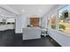 Cozy living room features light blue walls, a decorative fireplace, a large window and dark wood flooring at 1931 Selwyn Dr, Decatur, GA 30035