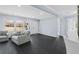 Bright living room featuring light blue walls, dark wood floors, and a large window for natural light at 1931 Selwyn Dr, Decatur, GA 30035