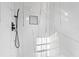 Modern shower showcasing elegant white marble-style tiles, black fixtures, and a convenient built-in niche at 1931 Selwyn Dr, Decatur, GA 30035