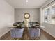 Modern dining room with a glass table, stylish chairs, and ample natural light from a large window at 204 Oak View Ln, Dallas, GA 30157