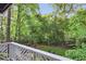 Backyard view from a private porch overlooking a lush green lawn, mature trees, and a playset at 560 Collier Nw Rd, Atlanta, GA 30318