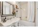 Bathroom featuring a shower with curtain, floral decorations and a sink with traditional faucet fixtures at 560 Collier Nw Rd, Atlanta, GA 30318