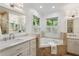 Bright bathroom with double vanity, soaking tub, and tile surround at 560 Collier Nw Rd, Atlanta, GA 30318