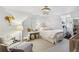 Bright bedroom featuring a decorative chandelier, a white armchair and a full sized crib at 560 Collier Nw Rd, Atlanta, GA 30318