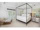 Bright bedroom featuring a four-poster bed, white linens, a ceiling fan, and access to a private balcony at 560 Collier Nw Rd, Atlanta, GA 30318