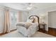 Bright bedroom featuring a ceiling fan, hardwood floors, and a window with blinds for natural light at 560 Collier Nw Rd, Atlanta, GA 30318