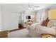 Bedroom features hardwood floors, a window with blinds, and a mounted television on the wall at 560 Collier Nw Rd, Atlanta, GA 30318