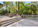 Wooden deck featuring a light wood table, a variety of planted herbs and woven armchairs at 560 Collier Nw Rd, Atlanta, GA 30318