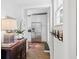 Bright entryway with hardwood floors, leading to a kitchen with stainless steel appliances and white cabinets at 560 Collier Nw Rd, Atlanta, GA 30318