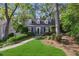 Charming two-story home featuring lush landscaping and a welcoming walkway leading to the front entrance at 560 Collier Nw Rd, Atlanta, GA 30318