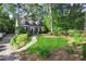 Charming two-story home featuring lush landscaping and a welcoming walkway leading to the front entrance at 560 Collier Nw Rd, Atlanta, GA 30318