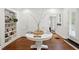 Welcoming foyer with a round table, built-in shelving, and hardwood floors at 560 Collier Nw Rd, Atlanta, GA 30318