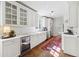 Well-lit kitchen with white cabinets, stainless steel appliances, and hardwood floors at 560 Collier Nw Rd, Atlanta, GA 30318