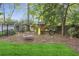 Backyard featuring a wooden playset with a slide, swings, and a tire swing on wood mulch at 560 Collier Nw Rd, Atlanta, GA 30318