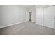 Bedroom featuring neutral carpet, closet, and access to another room at 144 Laurel Farms Ln, Dallas, GA 30157