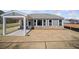 Home exterior featuring covered patio and newly seeded lawn at 144 Laurel Farms Ln, Dallas, GA 30157