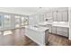 Modern kitchen with gray cabinets, an island with a sink, stainless steel appliances, and hardwood flooring at 144 Laurel Farms Ln, Dallas, GA 30157