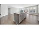 Kitchen island with gray cabinets, stainless steel appliances, and hardwood flooring at 144 Laurel Farms Ln, Dallas, GA 30157