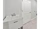 Functional laundry room featuring a utility sink, door to the outside, and tile floor at 144 Laurel Farms Ln, Dallas, GA 30157