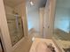 Well-lit bathroom with shower, tub, and sink with patterned floors at 1854 Brittlebank Ln, Lawrenceville, GA 30043