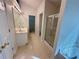 Bright bathroom featuring a double sink vanity, shower, and patterned tile flooring at 1854 Brittlebank Ln, Lawrenceville, GA 30043