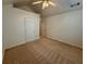 Bedroom with a ceiling fan, a large closet door, and neutral carpeting at 1854 Brittlebank Ln, Lawrenceville, GA 30043