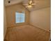 Bright bedroom featuring a ceiling fan and a large arched window bringing in natural light at 1854 Brittlebank Ln, Lawrenceville, GA 30043