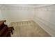 Spacious walk-in closet with ample shelving and carpeted floor at 1854 Brittlebank Ln, Lawrenceville, GA 30043