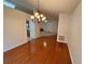 Formal dining room with hardwood floors, chandelier, and view to living room and kitchen at 1854 Brittlebank Ln, Lawrenceville, GA 30043