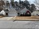 Charming one-story home with a two car garage, vinyl siding, and well-maintained front lawn in a suburban neighborhood at 1854 Brittlebank Ln, Lawrenceville, GA 30043