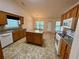 Open kitchen with an island, white appliances, and wood cabinetry at 1854 Brittlebank Ln, Lawrenceville, GA 30043