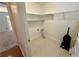 Laundry room with ample shelving and flooring at 1854 Brittlebank Ln, Lawrenceville, GA 30043