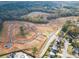 Aerial view of a new construction community with roads and homes being built in Oakleigh Glen at 206 Oak View Ln, Dallas, GA 30157