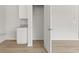Walk in closet with white storage and a wooden floor at 206 Oak View Ln, Dallas, GA 30157