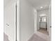 Hallway view with neutral walls, plush carpeting, and access to other rooms at 206 Oak View Ln, Dallas, GA 30157