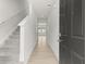 Hallway that leads to the living room with an elegant stairway with carpet at 206 Oak View Ln, Dallas, GA 30157