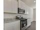 Galley kitchen features granite countertops, stainless steel oven, and white cabinets at 206 Oak View Ln, Dallas, GA 30157