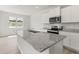 Bright kitchen features granite countertops, a stainless steel microwave, and a functional island at 206 Oak View Ln, Dallas, GA 30157