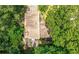 Aerial view of a home's roof and deck surrounded by mature trees and lush greenery at 2235 Six Branches Dr, Roswell, GA 30076