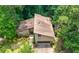 Aerial view of a home surrounded by mature trees and lush greenery at 2235 Six Branches Dr, Roswell, GA 30076