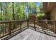 The back deck is wooden and provides space to enjoy a wooded view at 2235 Six Branches Dr, Roswell, GA 30076